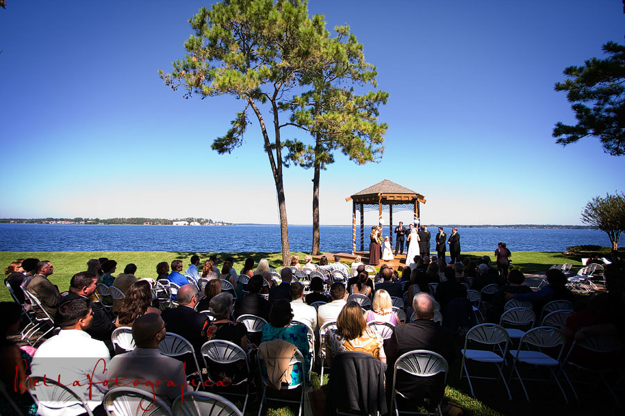outdoor wedding ceremony at waters edge unde the gazebo