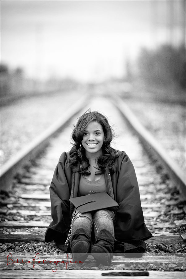 high school senior sitting on railroad tracks