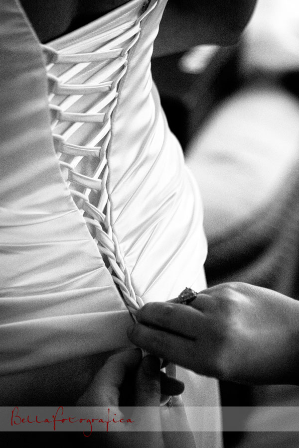 wedding dress being laced up