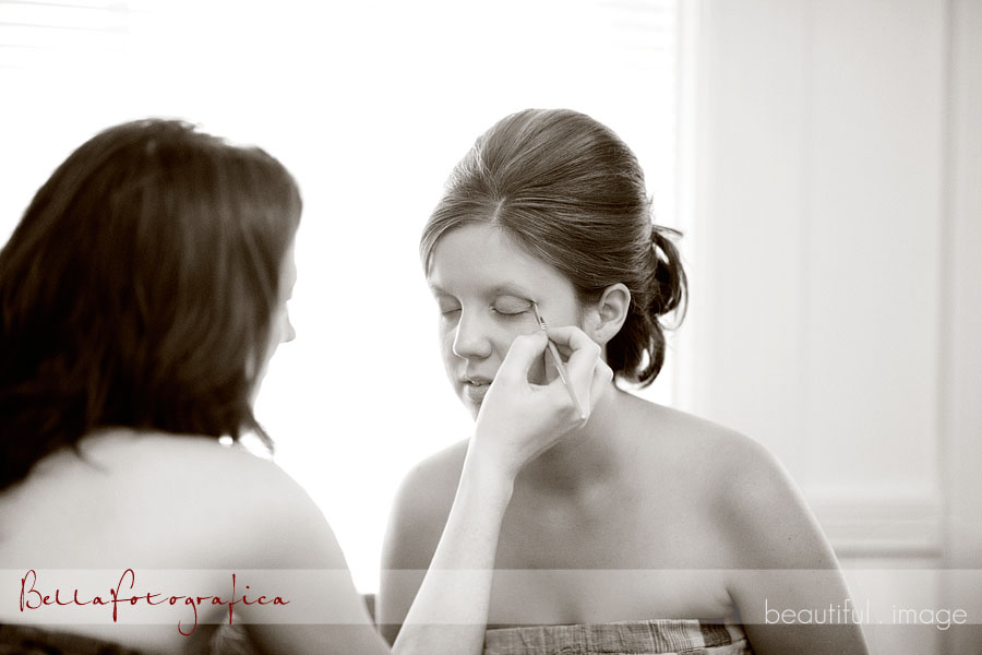 Bride applying makeup