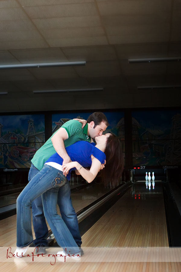 kiss during the engagement session at bowling alley