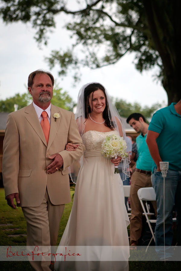 bride walking down the aisle escorted by her father