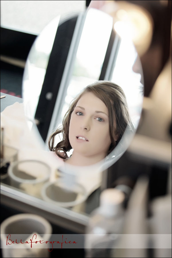 pensive bride looking in mirror