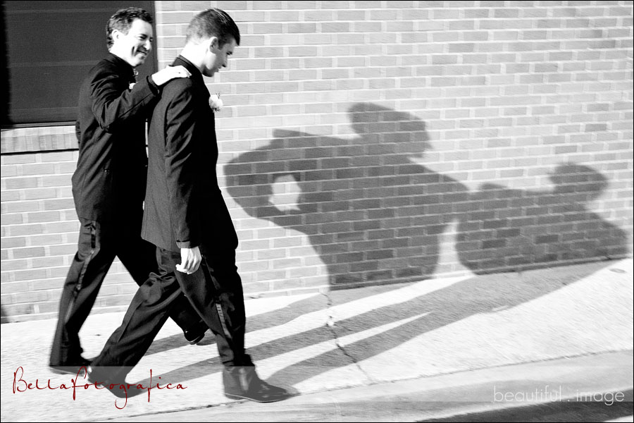 groom and best man walking with shadows