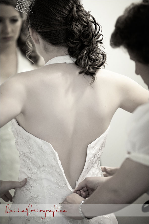 bride getting dress zipped up