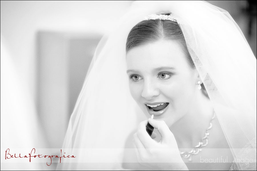 bride touching up her lipstick
