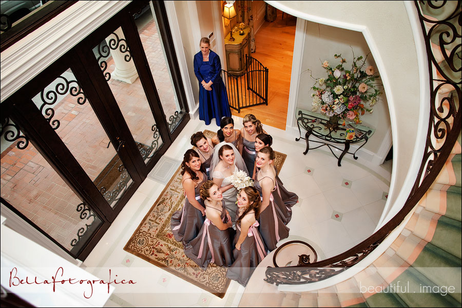 bride and bridesmaids at bottom of staircase
