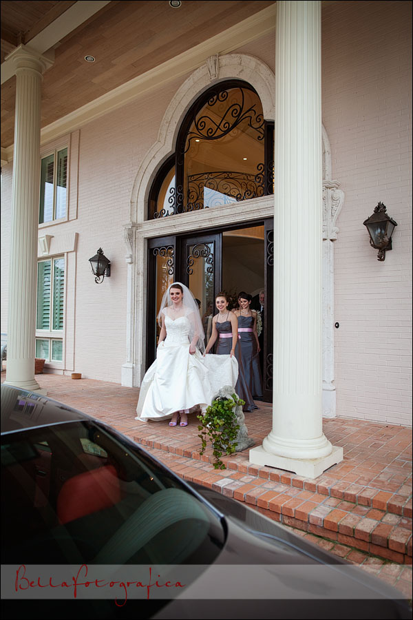 bride and bridesmaids walking out of house mazeratti in forground