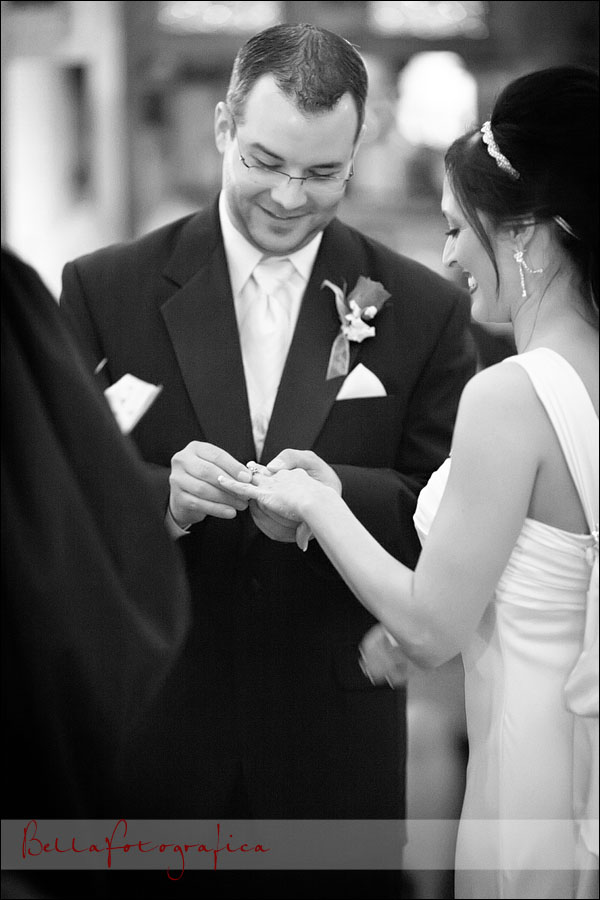 groom placing ring on brides finger