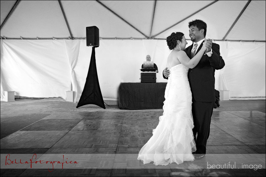 bride and groom dance at their outdoor tented wedding reception