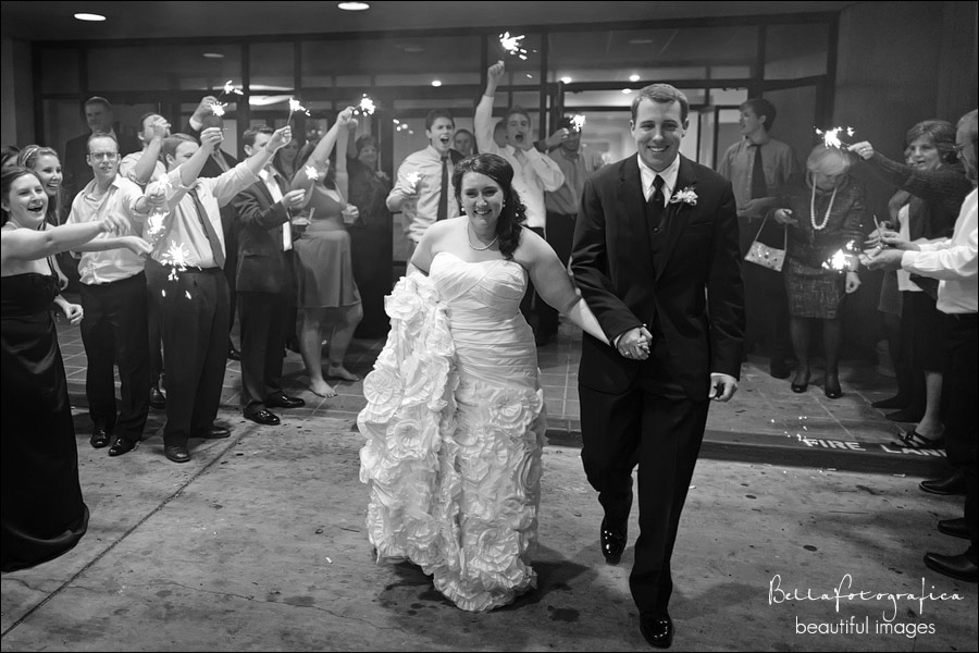 groom and bride leaving to sparklers