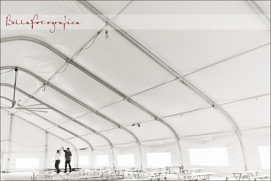 engaged couple dancing under the tent