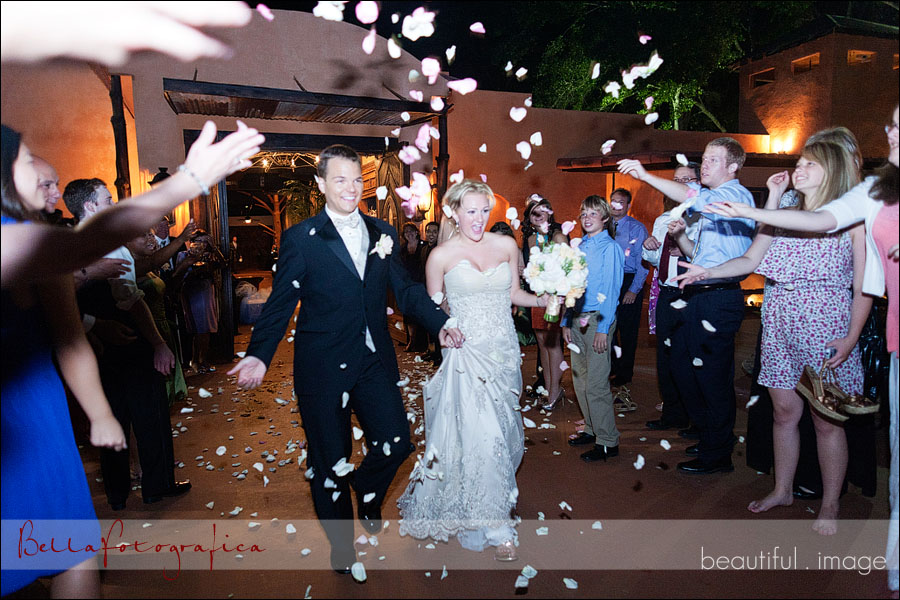 bride and groom leaving in rose petals