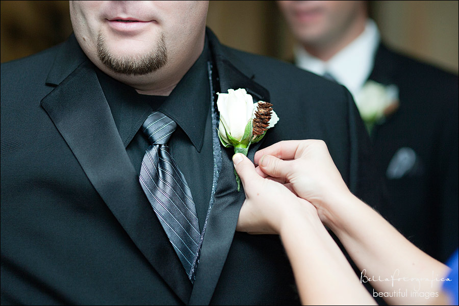 groom getting his boutonniere fastened