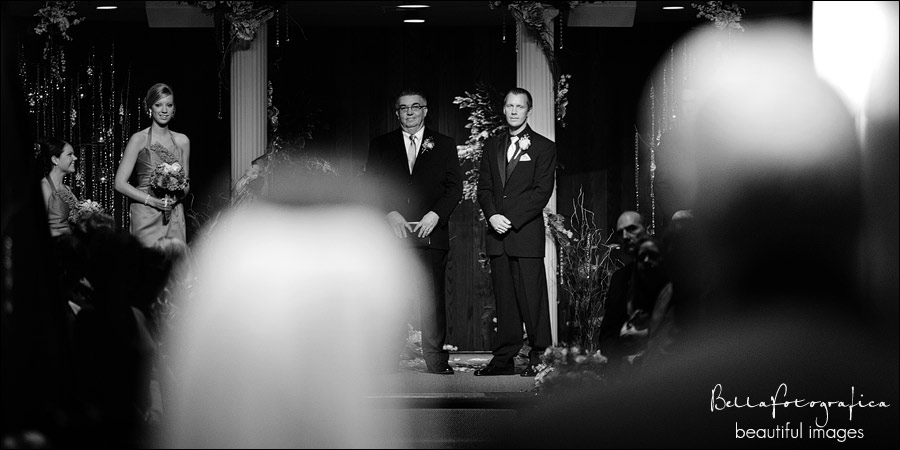 groom watching as bride makes her entrance with her dad